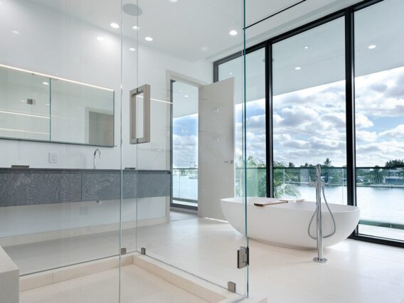 Villa Nova residence bathroom with glass shower and view of the water