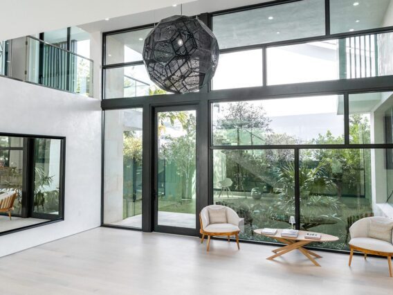 Villa Nova residence interior, with a glass wall looking into the yard