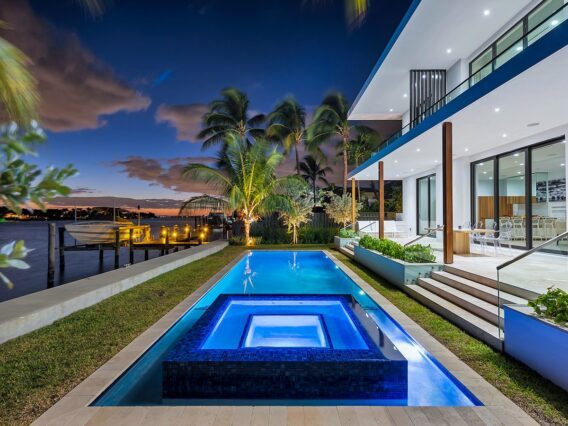 Villa Nova night shot of pool, hot tub, patio and palm trees