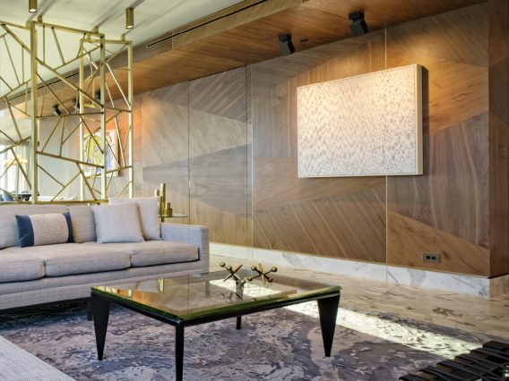 Carillon Miami residence living room with custom wood walls and brass sculpture
