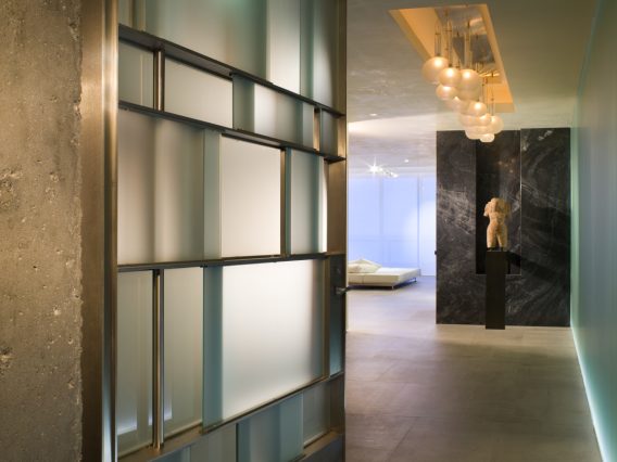 Continuum Miami residence hallway floor-to-ceiling glass panels