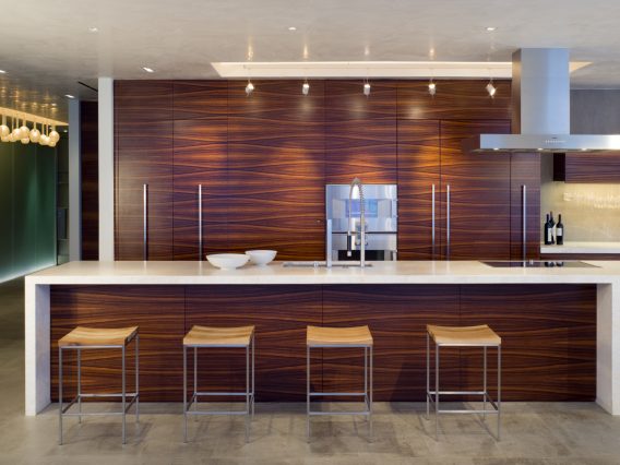 Continuum Miami residence kitchen bar with wood floor-to-ceiling backdrop